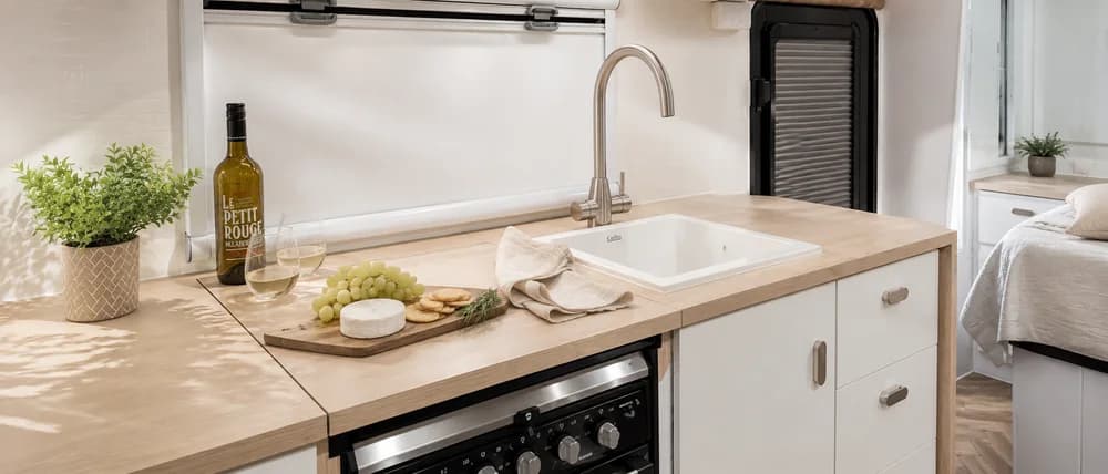 Light kitchen scheme — timber benchtop and ceramic sink
