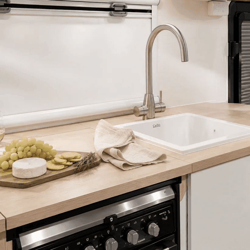Light kitchen scheme — timber benchtop and ceramic sink